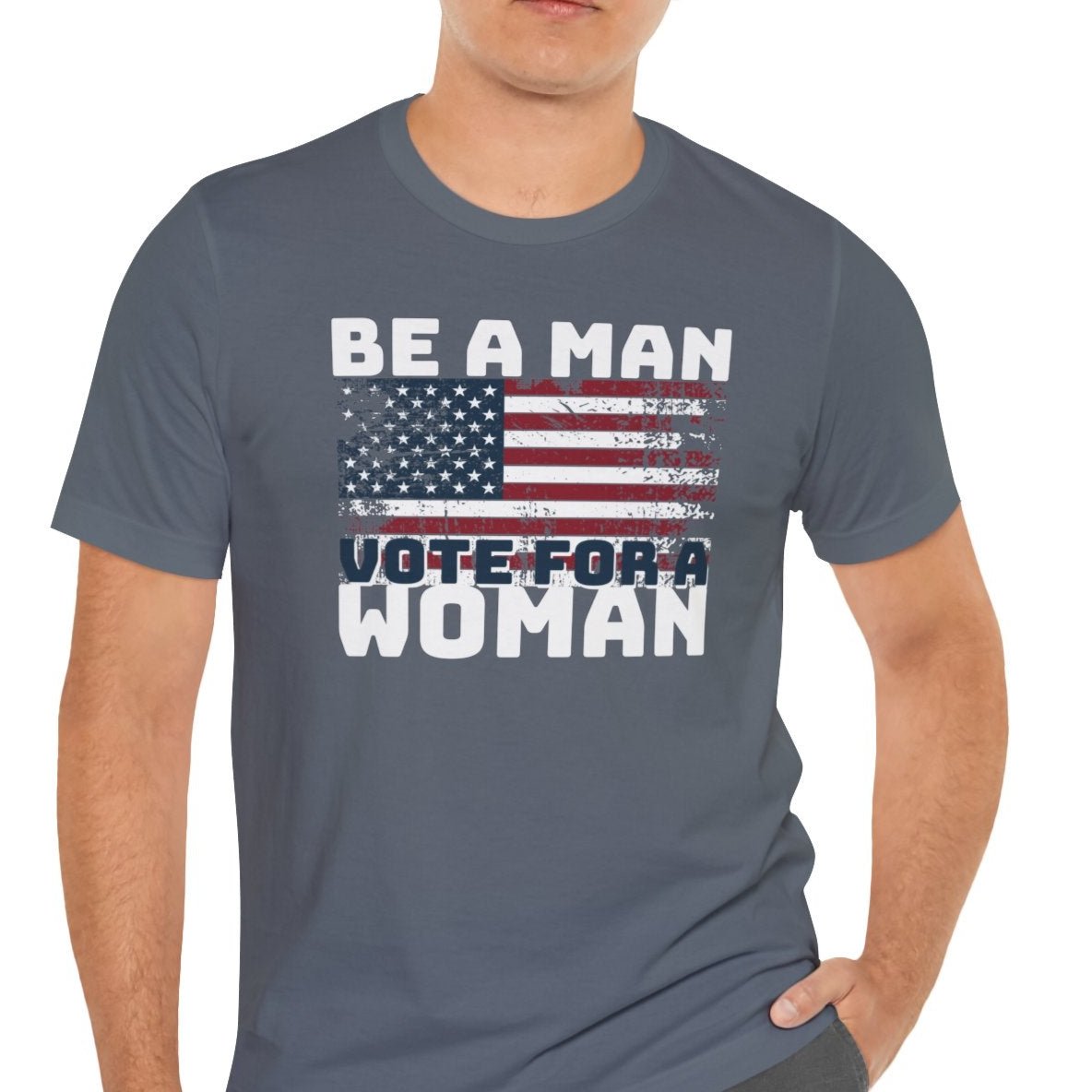 Be a Man, Vote for a Woman' design featuring the American flag in a distressed style, perfect for the upcoming 2024 election. This t-shirt gives off a patriotic and empowering vibe, ideal for those who want to make a statement with their clothing. It is relevant for political rallies, events, and everyday wear to show support for Kamala Harris for President in Election 2024.